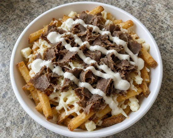 Bowl of donair poutine with fries, melted cheese, donair beef and donair sauce