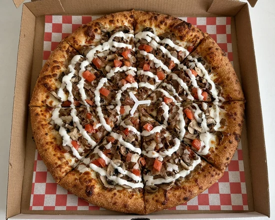 Loaded donair pizza drizzled with sweet donair sauce on a red-checked liner